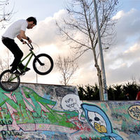 Joven practicando con su bicicleta distintas piruetas o trucos.